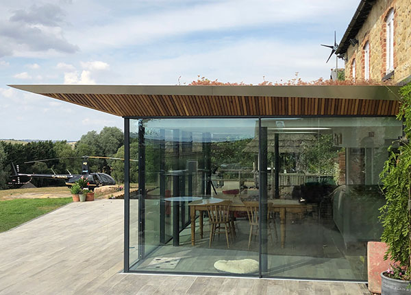 glass and green roof farmhouse extension