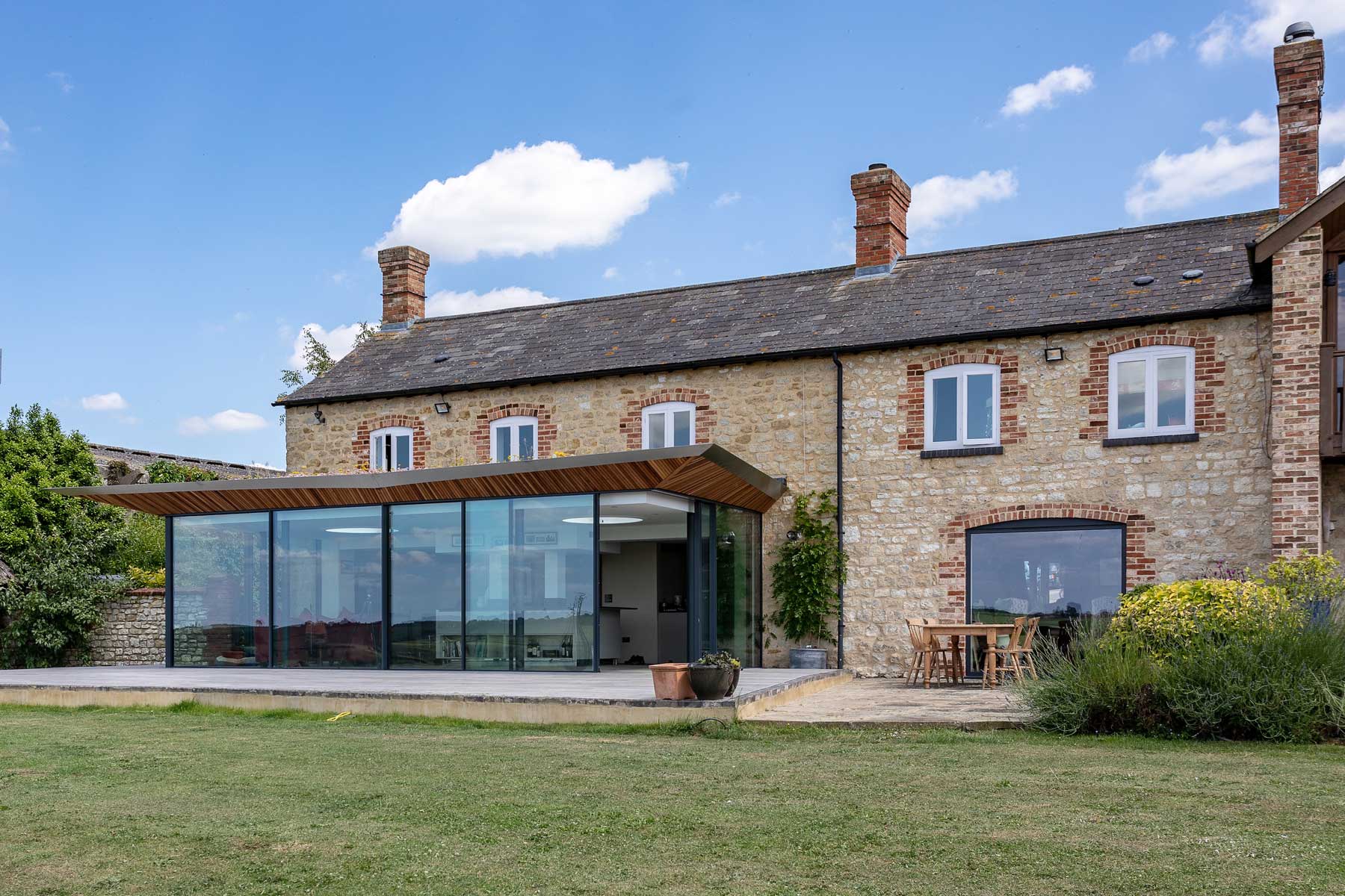 Glass and green roof farmhouse extension