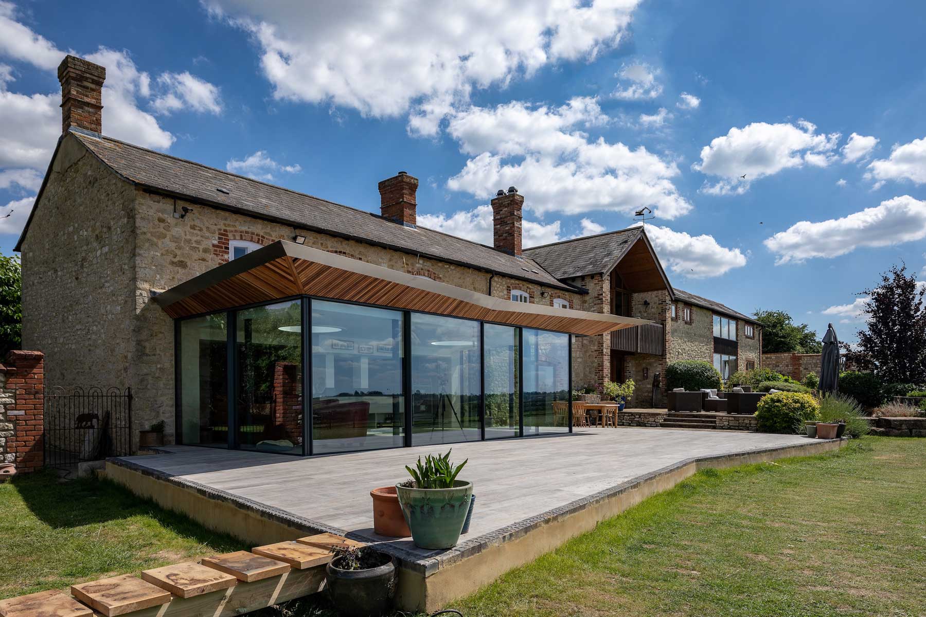 Glass and green roof farmhouse extension